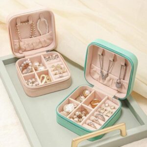 Elegant jewelry organizer box with compartments for rings, earrings, and necklaces in pastel colors